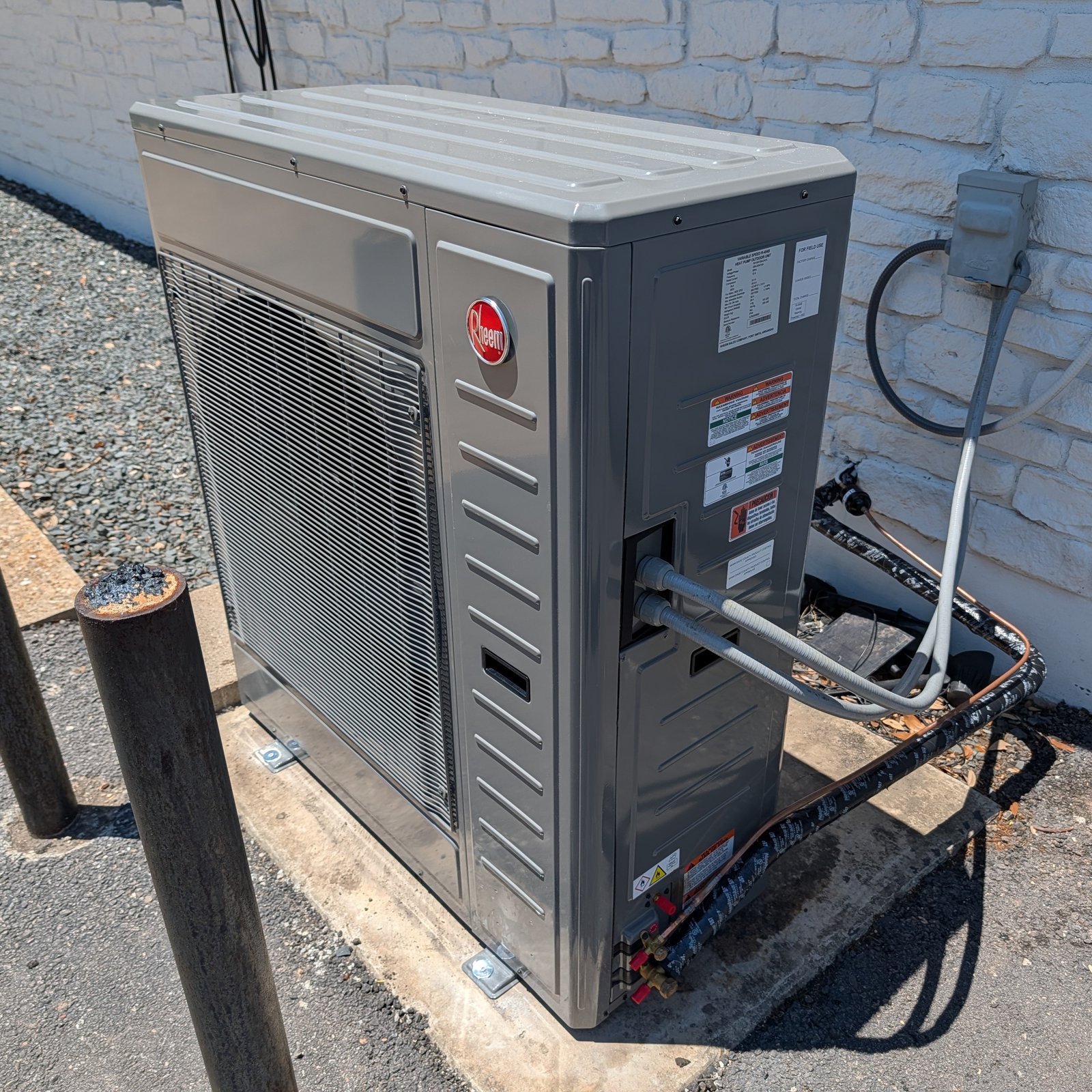 An Air Dynamics technician servicing an outdoor HVAC unit during an AC installation in Tulsa.