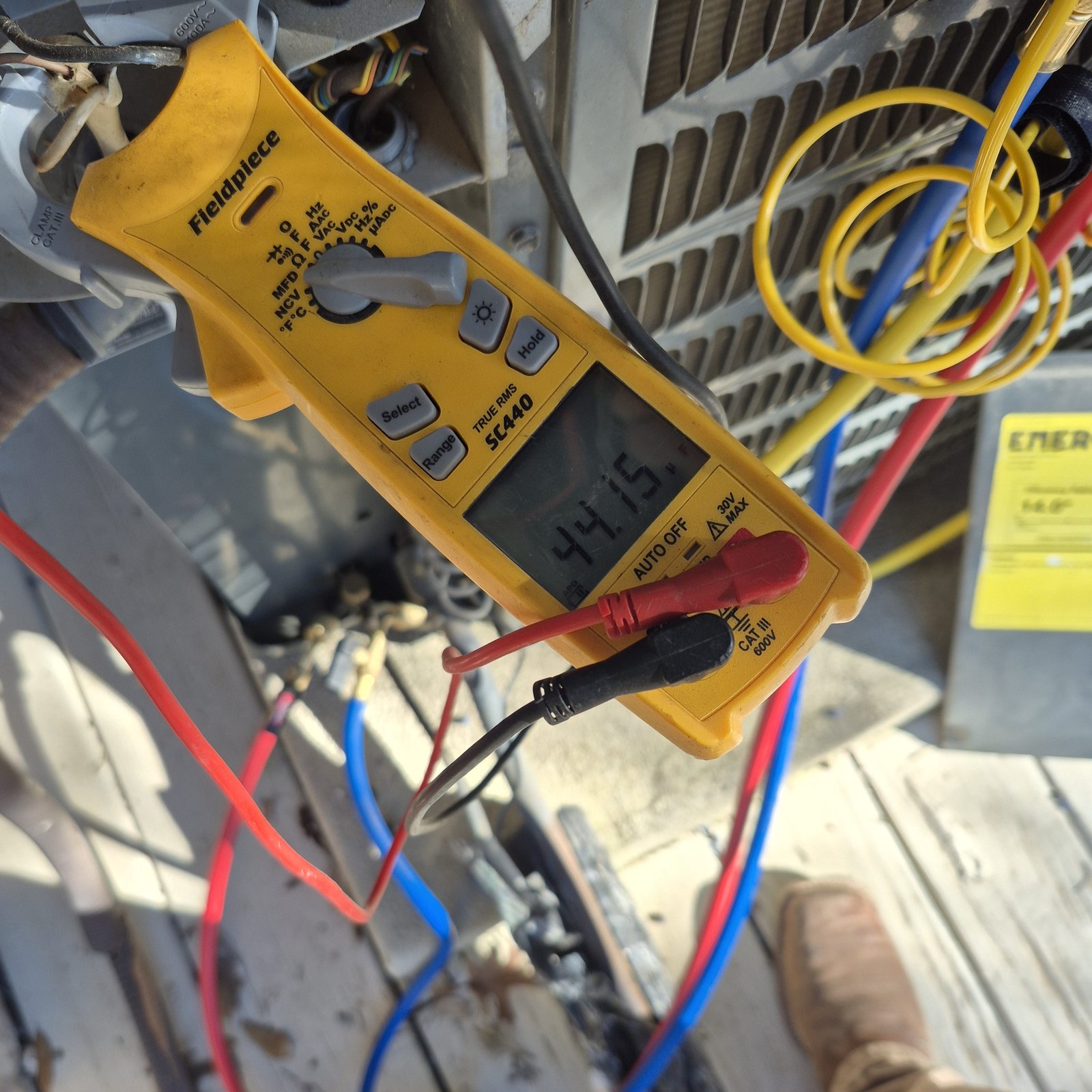 Honey Bee Heating and Air, LLC technician diagnosing an issue during an AC Tune Up service.
