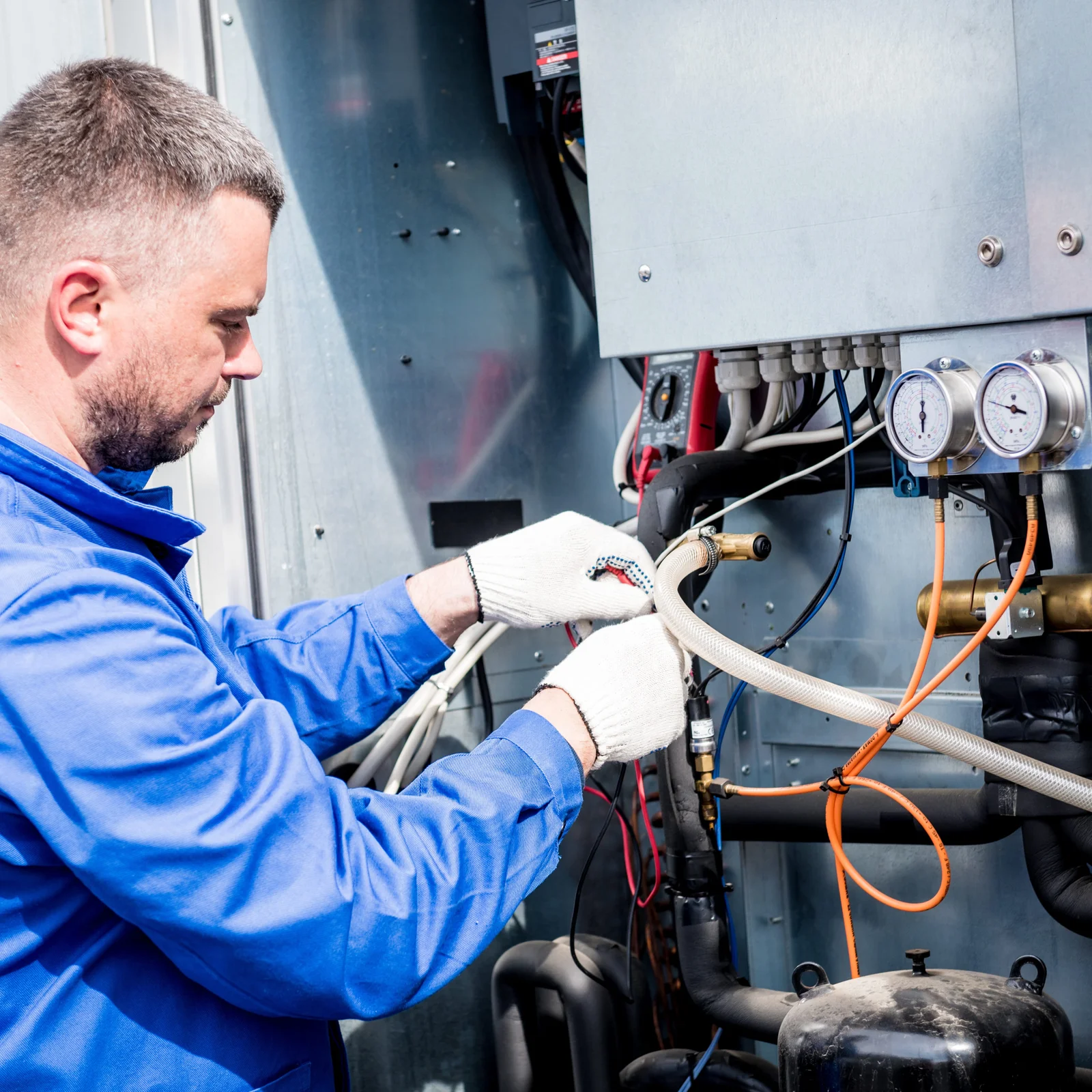 Technician servicing a wine cellar cooling system.